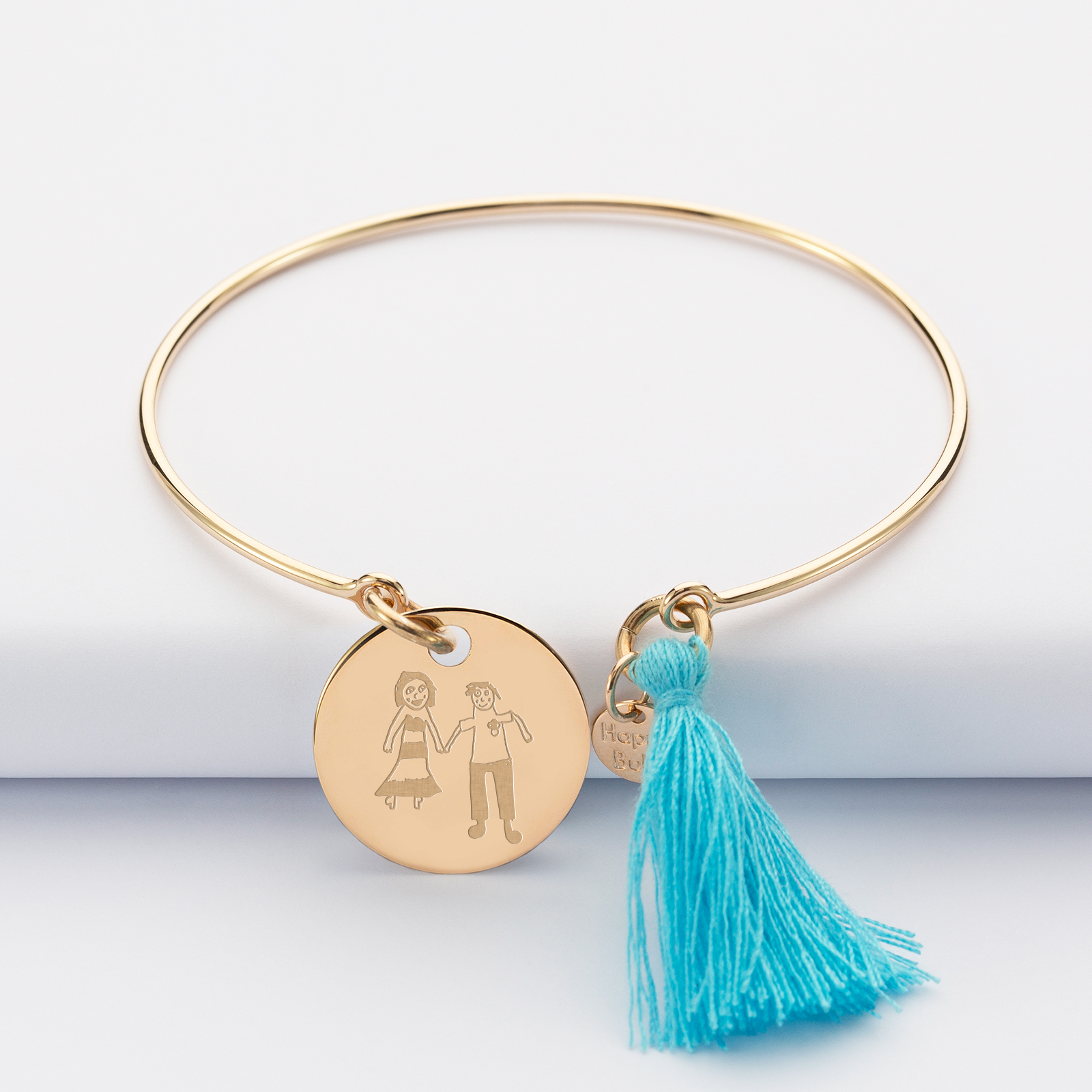 Personalised gold plate bangle with tassel and 19 mm engraved medallion sketch