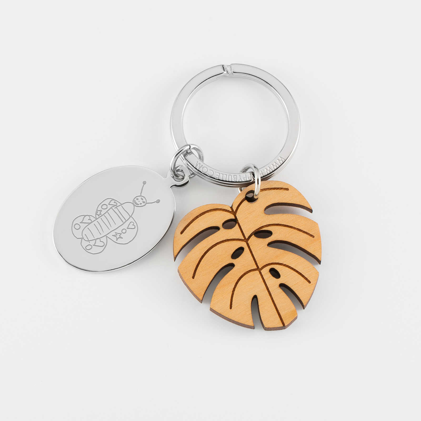 Porte clé personnalisé médaille gravée ovale acier et breloque bois feuille tropicale - dessin