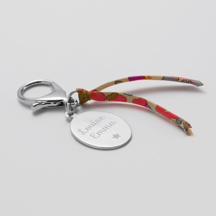 Bijou de sac personnalisé médaille gravée acier ovale 25x33 mm et noeud Liberty - prénoms 2